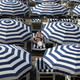 People sitting under umbrellas on the beach.